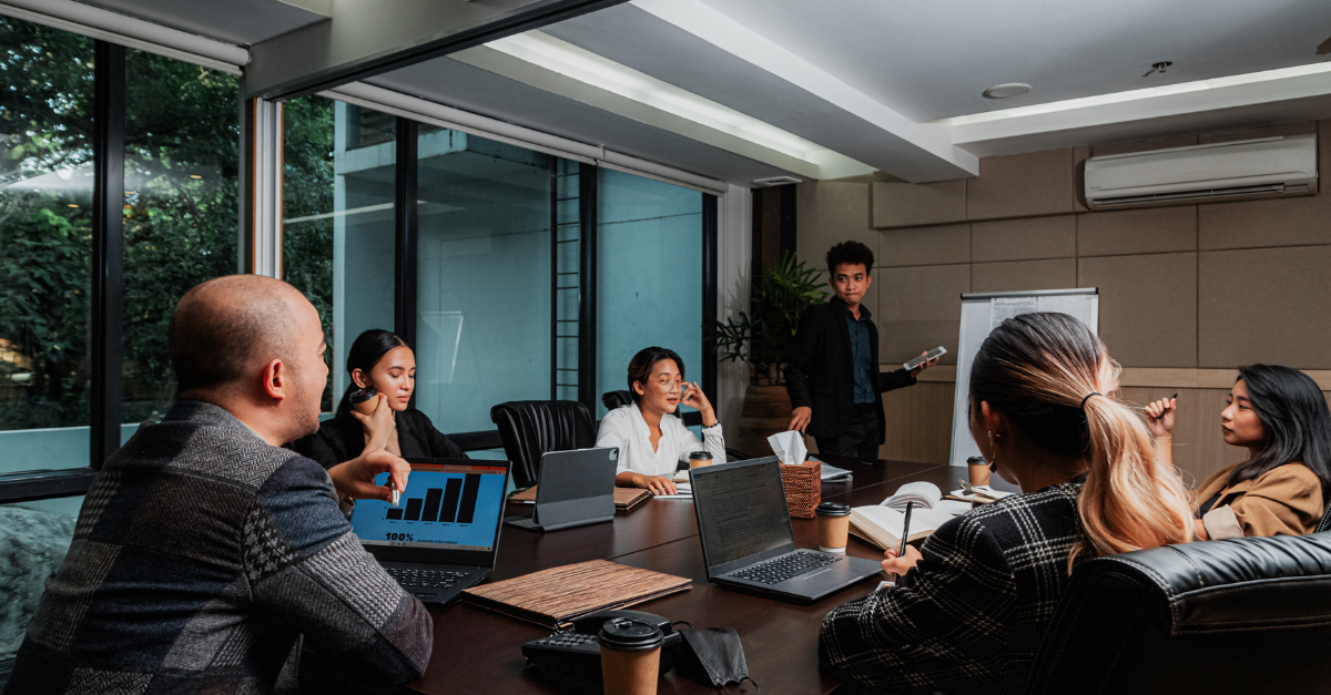 Marketing and sales team reviewing ABM tiers strategy on a whiteboard